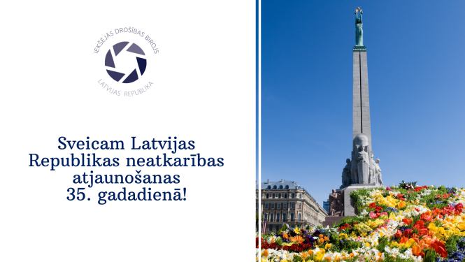 Apsveikums ar Brīvbas pieminekļa attēlu, kam pakājē ir pavasara ziedi, Ieksējās drošības biroja logo. Teksts Sveicam Latvijas Republikas neatkarības atjaunošanas 35.gadadienā